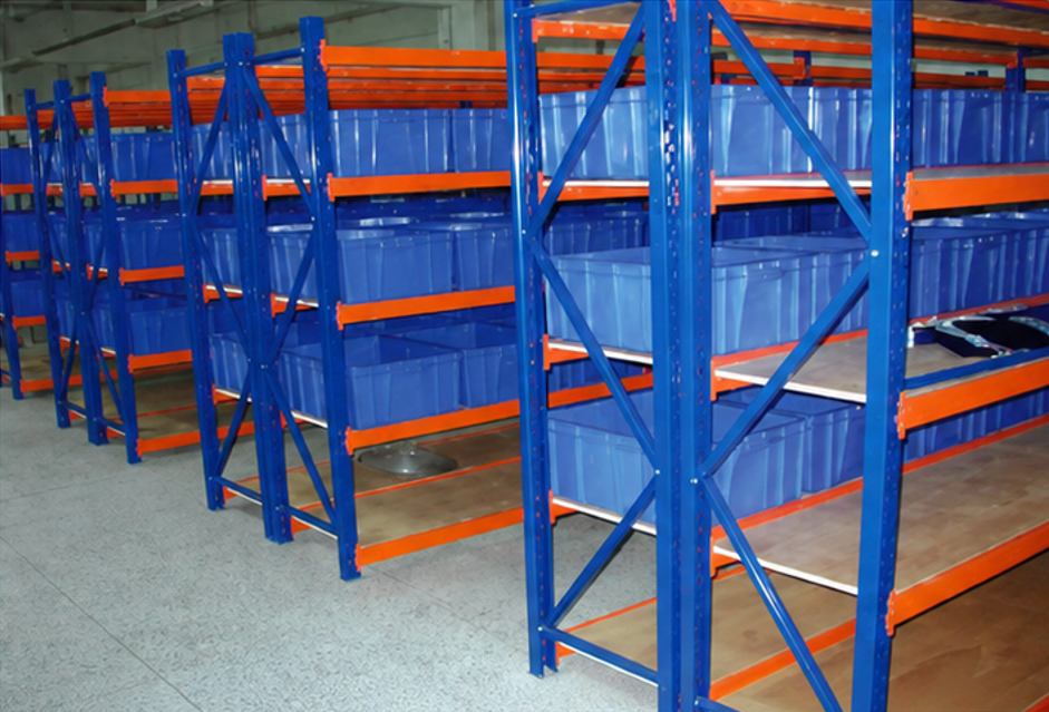 Blue and orange medium duty shelving installed in warehouse with storage bins