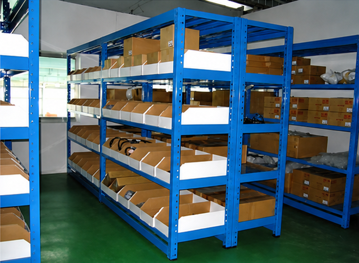 Blue industrial shelving system storing cartons and storage bins in warehouse